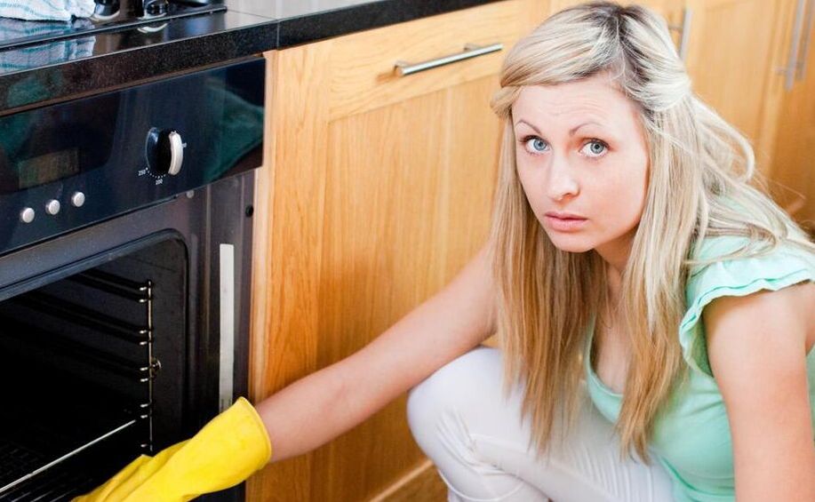 woman cleaning an oven