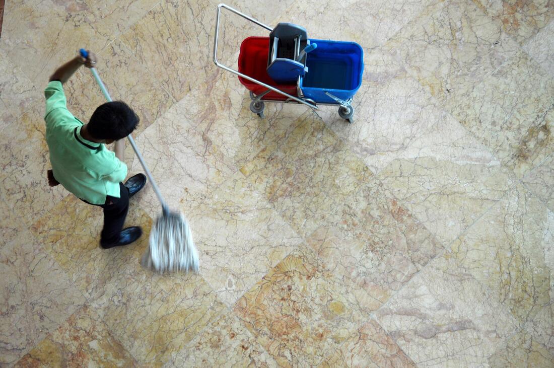 man mopping the floor